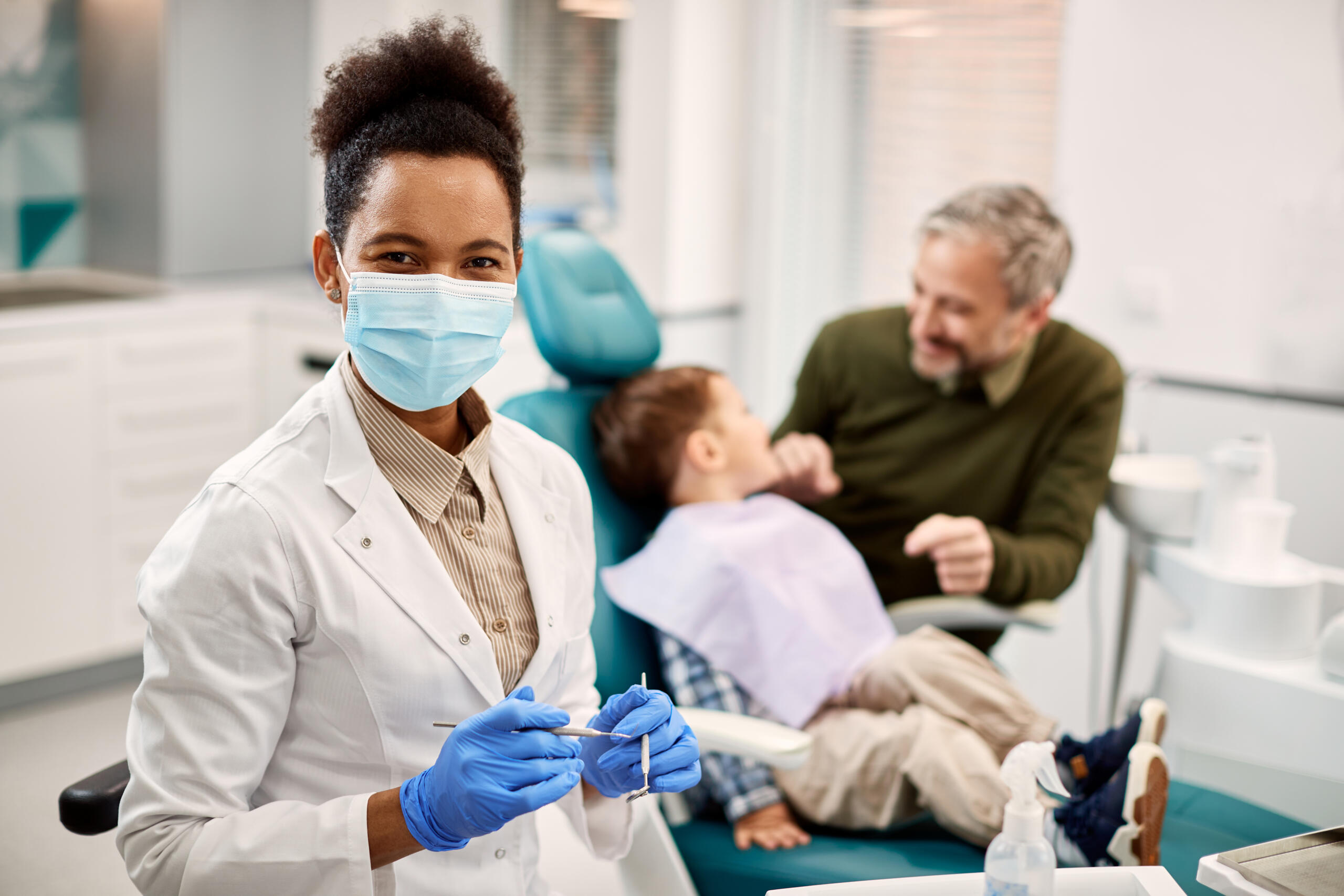 happy-black-pediatric-dentist-at-work-looking-at-c-2024-12-13-21-08-39-utc